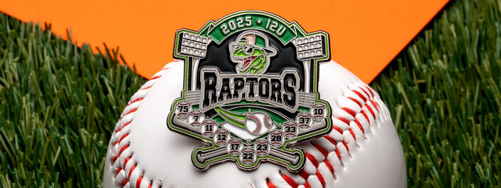Green Raptors 12U 2025 trading pin with a raptor head above crossed bats and player numbers, on a baseball on turf