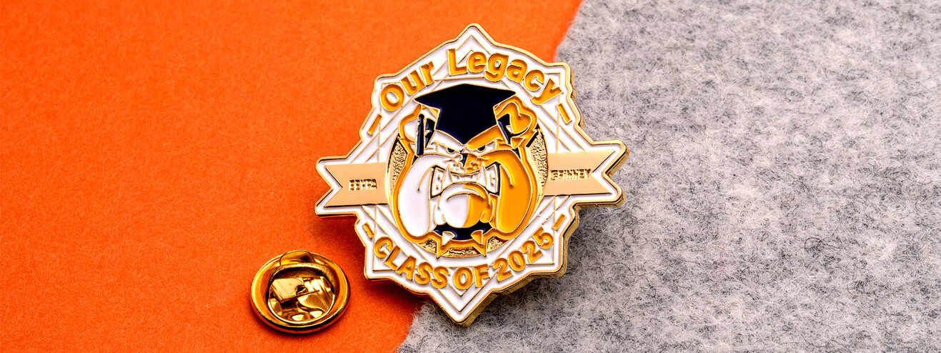 Gold Our Legacy Class of 2025 pin with a bulldog in a graduation cap, beside a gold clutch