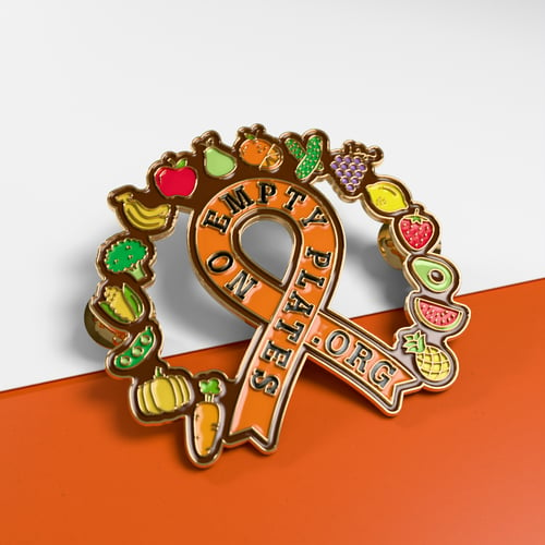 Custom ribbon pins with a wreath of fruits and vegetables around it. 